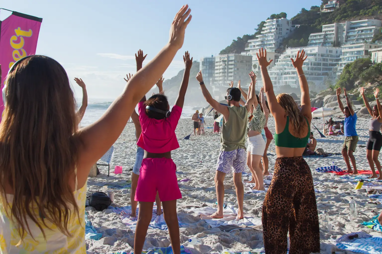 People practicing yoga on the beach at sunset in Cape Town