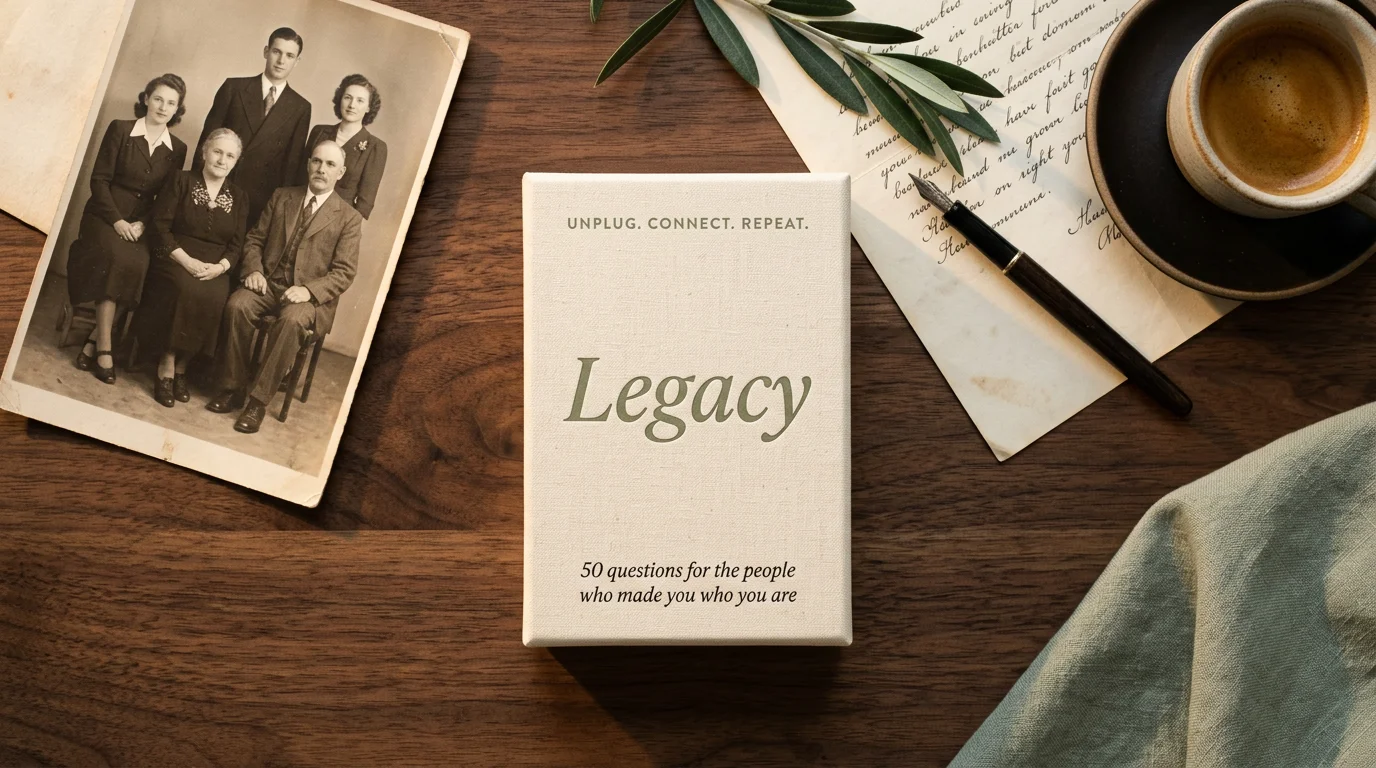 Connect Cards: Legacy deck box on a walnut table beside a vintage family portrait, a handwritten letter, a fountain pen and a sprig of olive leaves