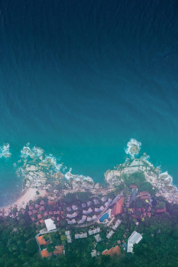 Aerial view of Vikasa resort on a clifftop overlooking turquoise waters