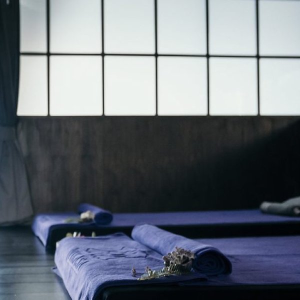 Massage beds prepared with towels and flowers at Vita Spa